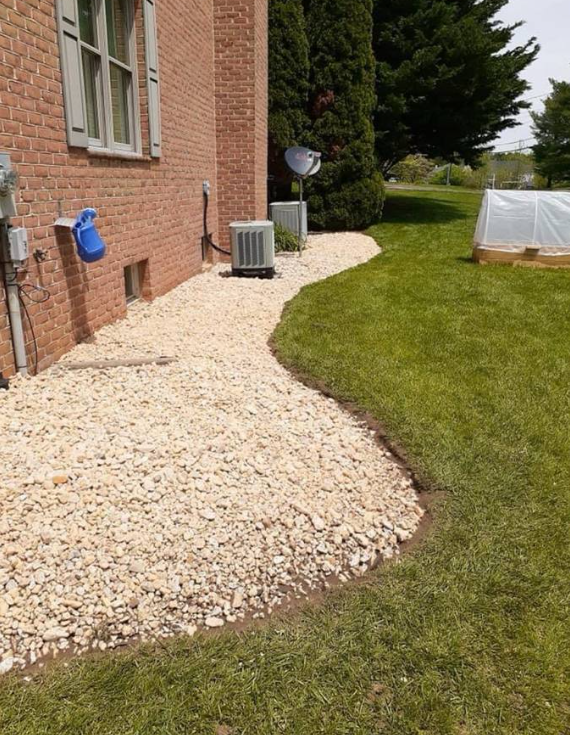 River stone landscape bed along home foundation